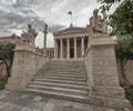 Plato and Socrates statues in front of the national academy of Athens, Greece under impressive cloudy sky