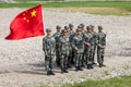 Platoon of Chinese soldiers with the flag of the Chinese People`s Republic