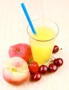 Platt peach, cherries, strawberry and juice in glass