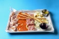 Platter of antipasti appetizers, with crusty breadsticks. meat and cheese platter, carpaccio with cut cheese