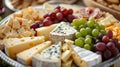 platter of assorted cheeses and grapes Royalty Free Stock Photo