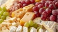 platter of assorted cheeses and grapes Royalty Free Stock Photo