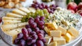 platter of assorted cheeses and grapes Royalty Free Stock Photo