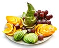 Platter of a assorted fresh fruit cut professionally on a white background Royalty Free Stock Photo