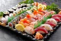 Platter of assorted sushi displayed on a table, A picturesque sushi platter with a variety of fresh fish and colorful garnishes Royalty Free Stock Photo