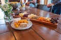 Platter of an assortment of cheese and fruit snacks on a wooden table
