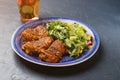 Platter of chicken thighs piri piri coated in hot sauce with salad. Royalty Free Stock Photo