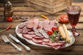 Platter of cold cuts. peppermint, red wine, fork and knife Royalty Free Stock Photo