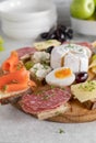 Platter with cold cuts sandwiches. Topped with smoked salmon, cheese, salami and boild eggs Royalty Free Stock Photo