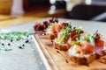 Platter: cold salmon bruschetta and greens with a glass of champagne Royalty Free Stock Photo