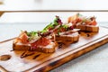 Platter: cold salmon bruschetta and greens with a glass of champagne Royalty Free Stock Photo