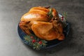 Platter of cooked turkey with cranberry and fir tree branches