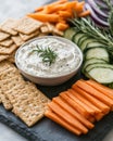 A platter with crackers, vegetables, and dip, perfect for a snack or appetizer Royalty Free Stock Photo