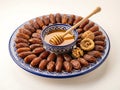 Platter of dates and honey with nuts isolated white background Royalty Free Stock Photo