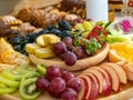 A platter of fresh fruit set on the table, ready to be served for breakfast