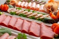 Platter of fresh meat cold cuts on table Royalty Free Stock Photo