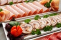 Platter of fresh meat cold cuts on table Royalty Free Stock Photo