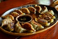platter of gyoza with dipping sauce on a restaurant table