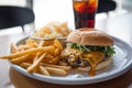 platter with halfeaten burger, side of fries, soda