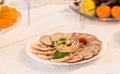 Platter of sliced ham,salami and cured meat with vegetable decoration on festive table Royalty Free Stock Photo