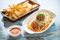 platter of spaghetti meatballs, garlic bread slices on side