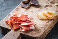 Platter with Spanish ham jamon serrano or Italian prosciutto crudo, homemade dried meat salami, sliced Italian hard cheese