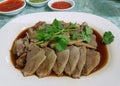 Platter of stewed duck garnished with cilantro