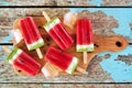 Platter of summer watermelon popsicles, top view over rustic blue wood Royalty Free Stock Photo
