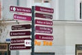 Plauen, Germany - March 28, 2023: Tourist information signpost on Town hall square with arrows pointing to main attractions of