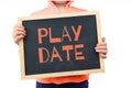 Play Date subject depicted with child holding blackboard.