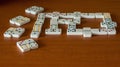 Play Dominoes on a wooden background. Gamble.