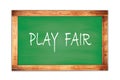 PLAY FAIR text written on green school board