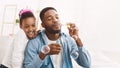 Play With Father. Dad And Daughter Blowing Soap Bubbles