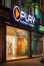Play Gadget store with subway signboard glowing at night