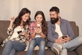 Play game application. Family surfing internet. Family leisure. Online family. Mom dad and daughter relaxing on couch Royalty Free Stock Photo