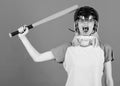 Play game for fun. Woman having fun during baseball game. Girl pretty blonde wear baseball helmet and hold bat on blue