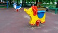 Play ground in summer park, empty swing and rocking horse