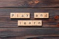 play and learn word written on wood block. play and learn text on cement table for your desing, concept Royalty Free Stock Photo