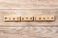 Play and learn word written on wood block. play and learn text on table, concept Royalty Free Stock Photo