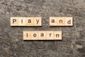 play and learn word written on wood block. play and learn text on table, concept Royalty Free Stock Photo