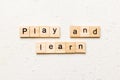 play and learn word written on wood block. play and learn text on table, concept Royalty Free Stock Photo