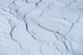 The play of light and shadow on the undulating slopes of white snowdrifts. The snow surface in the background lighting.