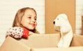 Play with me. Cardboard boxes - moving to new house. happy child cardboard box. happy little girl with toy. repair of Royalty Free Stock Photo