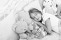 Play soft toy before go sleep. Sleep with toy. Carefree childhood. Relaxing before sleep. Girl enjoy evening time with