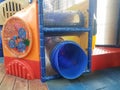 Play structure with netting and blue plastic slide