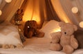 Play tent with toys and pillows indoors, closeup. Modern children`s room interior Royalty Free Stock Photo