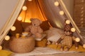 Play tent with toys and pillows indoors, closeup. Modern children`s room interior Royalty Free Stock Photo