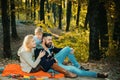 Play together. Mother father and small son play in park. Happy family with kid boy relaxing while hiking in forest Royalty Free Stock Photo