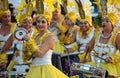 Female Carnival Dancers and drummers in Flamboyant Yellow Costumes.