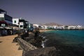 PLAYA BLANCA, LANZAROTE - JUIN 9. 2019: View on cityscape with promenade at ocean in lagoon with white houses